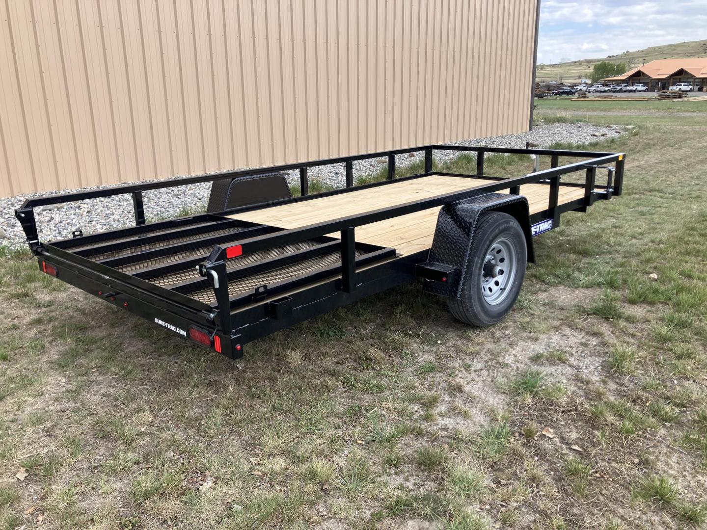 2026 , located at 40 Big Timber RD, Big Timber, MT, 59011, (406) 901-0517, 45.836796, -109.943535 - New SureTrac 7 x 14 Utility Trailer, 5k GVW single axle with electric brakes, 15"-8 ply radial tires, 2" x 2" tube - top rail, 2" x 2" tube uprights, stake pockets, 2k top wind jack, treated wood deck, (3) position rear gate, 2" coupler, all lights LED, spare tire mount, powder coat finish. Optio - Photo#1