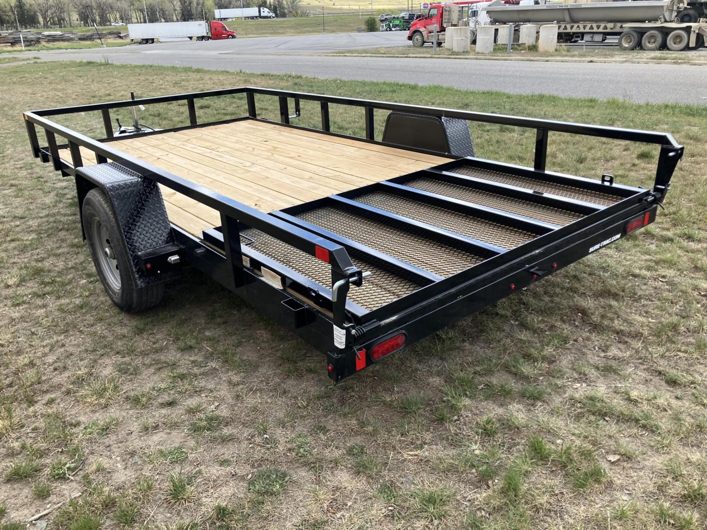 2026 , located at 40 Big Timber RD, Big Timber, MT, 59011, (406) 901-0517, 45.836796, -109.943535 - New SureTrac 7 x 14 Utility Trailer, 5k GVW single axle with electric brakes, 15"-8 ply radial tires, 2" x 2" tube - top rail, 2" x 2" tube uprights, stake pockets, 2k top wind jack, treated wood deck, (3) position rear gate, 2" coupler, all lights LED, spare tire mount, powder coat finish. Optio - Photo#2