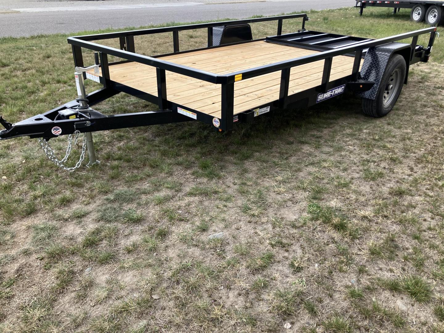 2026 , located at 40 Big Timber RD, Big Timber, MT, 59011, (406) 901-0517, 45.836796, -109.943535 - New SureTrac 7 x 14 Utility Trailer, 5k GVW single axle with electric brakes, 15"-8 ply radial tires, 2" x 2" tube - top rail, 2" x 2" tube uprights, stake pockets, 2k top wind jack, treated wood deck, (3) position rear gate, 2" coupler, all lights LED, spare tire mount, powder coat finish. Optio - Photo#3