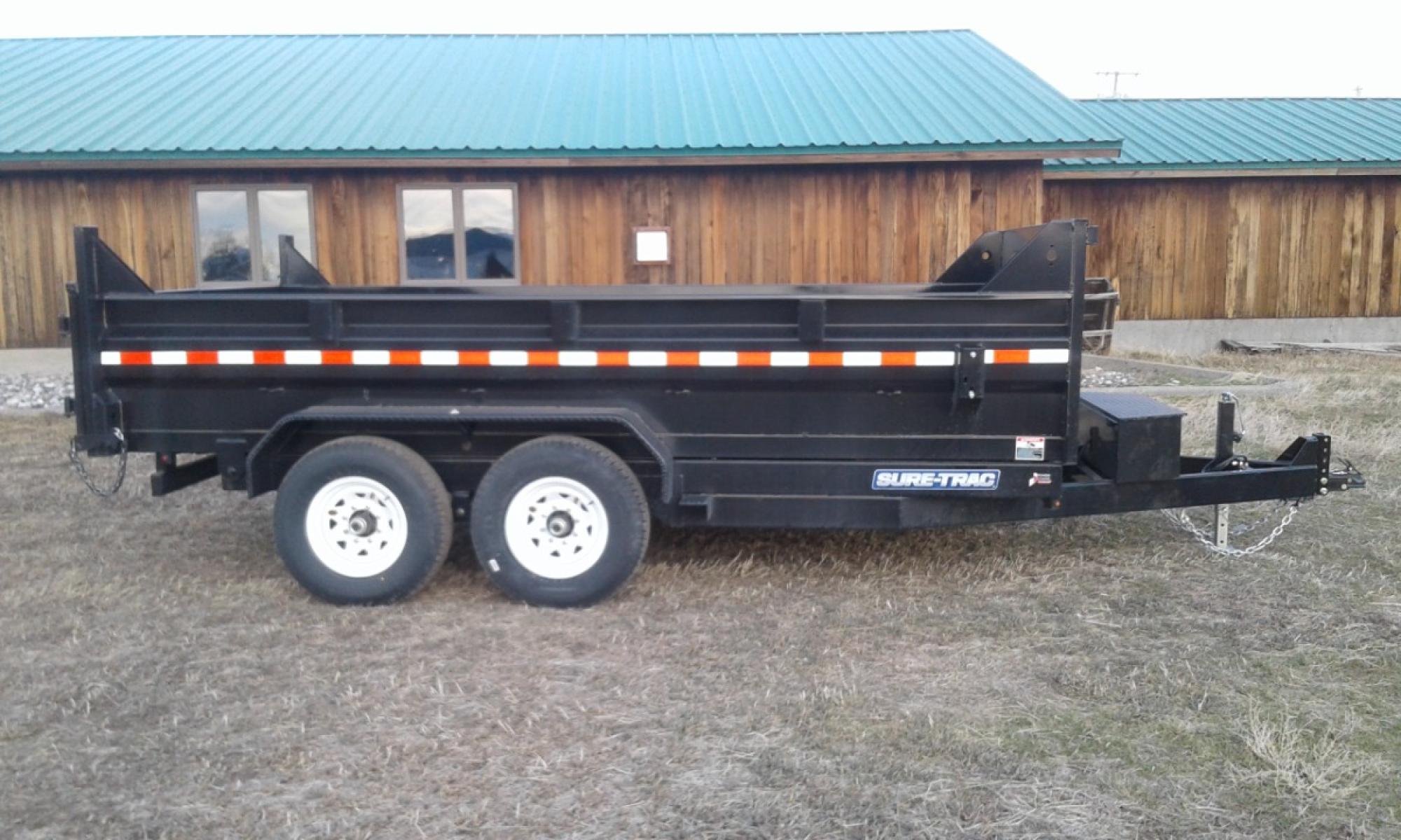 2023 Black SureTrac 7 x 14 LoPro Dump , located at 310 West 1st Ave, Big Timber, MT, 59011, (406) 860-8510, 45.833511, -109.957809 - SURE-TRAC 7 x 14 LO PRO DUMP TRAILER, 14K GVW, CHOICE OF DUAL RAM, SCISSOR OR TELESCOPIC HOIST, UNDERBODY TOOL STORAGE BOX, STAKE POCKETS ON SIDE, MESH TARP, 110 VOLT BATTERY CHARGER, SIDE STEP, EZ LUBE HUBS, HD SLIPPER SPRING SUSPENSION, 16" RADIAL 10 PLY TIRES, BRAKES BOTH AXLES, SPREADER-BARN DOO - Photo #0