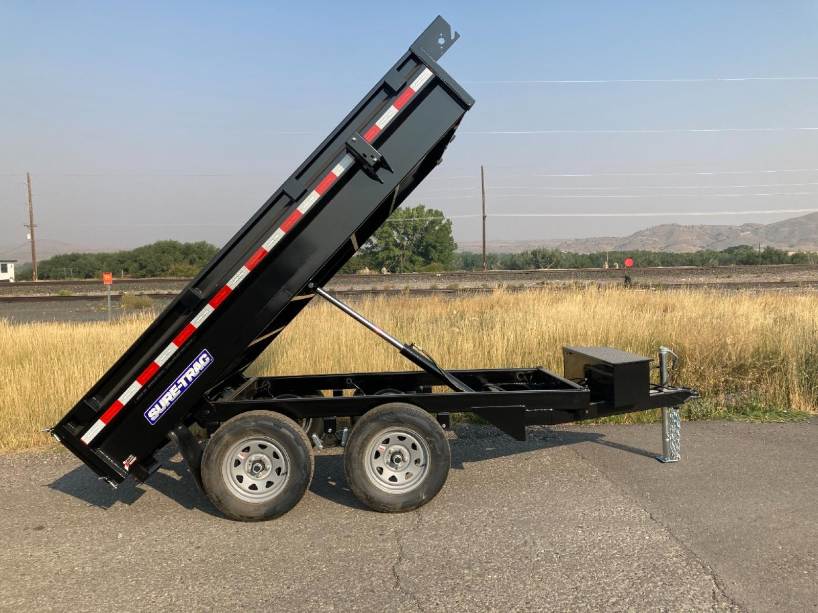 2023 Black SureTrac 6 x 10 Deckover Dump Trailer , located at 310 West 1st Ave, Big Timber, MT, 59011, (406) 860-8510, 45.833511, -109.957809 - ONE OF THE LITTLE WORKHORES'- THIS DECKOVER DUMP IS GREAT FOR AROUND THE HOUSE AND SMALL ACERAGES. DON'T LET THE SIZE AND PRICE FOOL YOU, THIS UNIT WILL DO A LOT OF WORK! 6' X 10' DECKOVER DUMP, 7K GVW, SINGLE RAM HOIST, DUAL REAR GATE, BRAKES BOTH AXLES, EZ LUBE HUBS, LED LIGHTS, POWDERCOAT FINIS - Photo #0