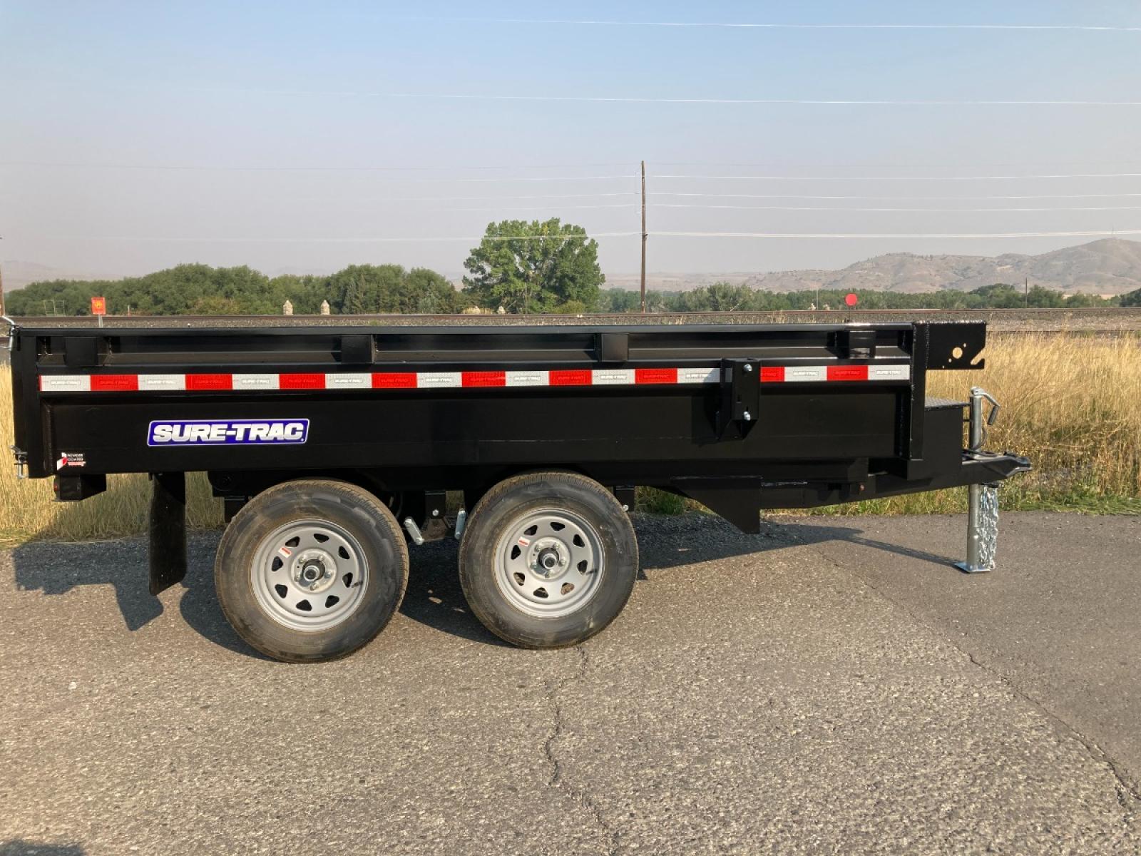 2023 Black SureTrac 6 x 10 Deckover Dump Trailer , located at 310 West 1st Ave, Big Timber, MT, 59011, (406) 860-8510, 45.833511, -109.957809 - ONE OF THE LITTLE WORKHORES'- THIS DECKOVER DUMP IS GREAT FOR AROUND THE HOUSE AND SMALL ACERAGES. DON'T LET THE SIZE AND PRICE FOOL YOU, THIS UNIT WILL DO A LOT OF WORK! 6' X 10' DECKOVER DUMP, 7K GVW, SINGLE RAM HOIST, DUAL REAR GATE, BRAKES BOTH AXLES, EZ LUBE HUBS, LED LIGHTS, POWDERCOAT FINIS - Photo #1