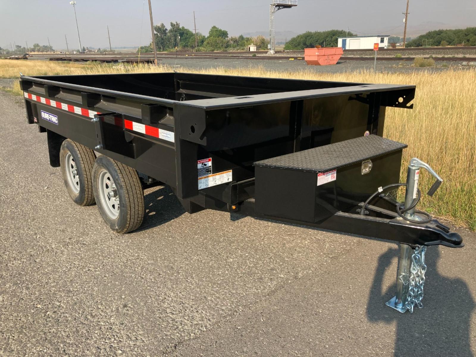 2023 Black SureTrac 6 x 10 Deckover Dump Trailer , located at 310 West 1st Ave, Big Timber, MT, 59011, (406) 860-8510, 45.833511, -109.957809 - ONE OF THE LITTLE WORKHORES'- THIS DECKOVER DUMP IS GREAT FOR AROUND THE HOUSE AND SMALL ACERAGES. DON'T LET THE SIZE AND PRICE FOOL YOU, THIS UNIT WILL DO A LOT OF WORK! 6' X 10' DECKOVER DUMP, 7K GVW, SINGLE RAM HOIST, DUAL REAR GATE, BRAKES BOTH AXLES, EZ LUBE HUBS, LED LIGHTS, POWDERCOAT FINIS - Photo #4