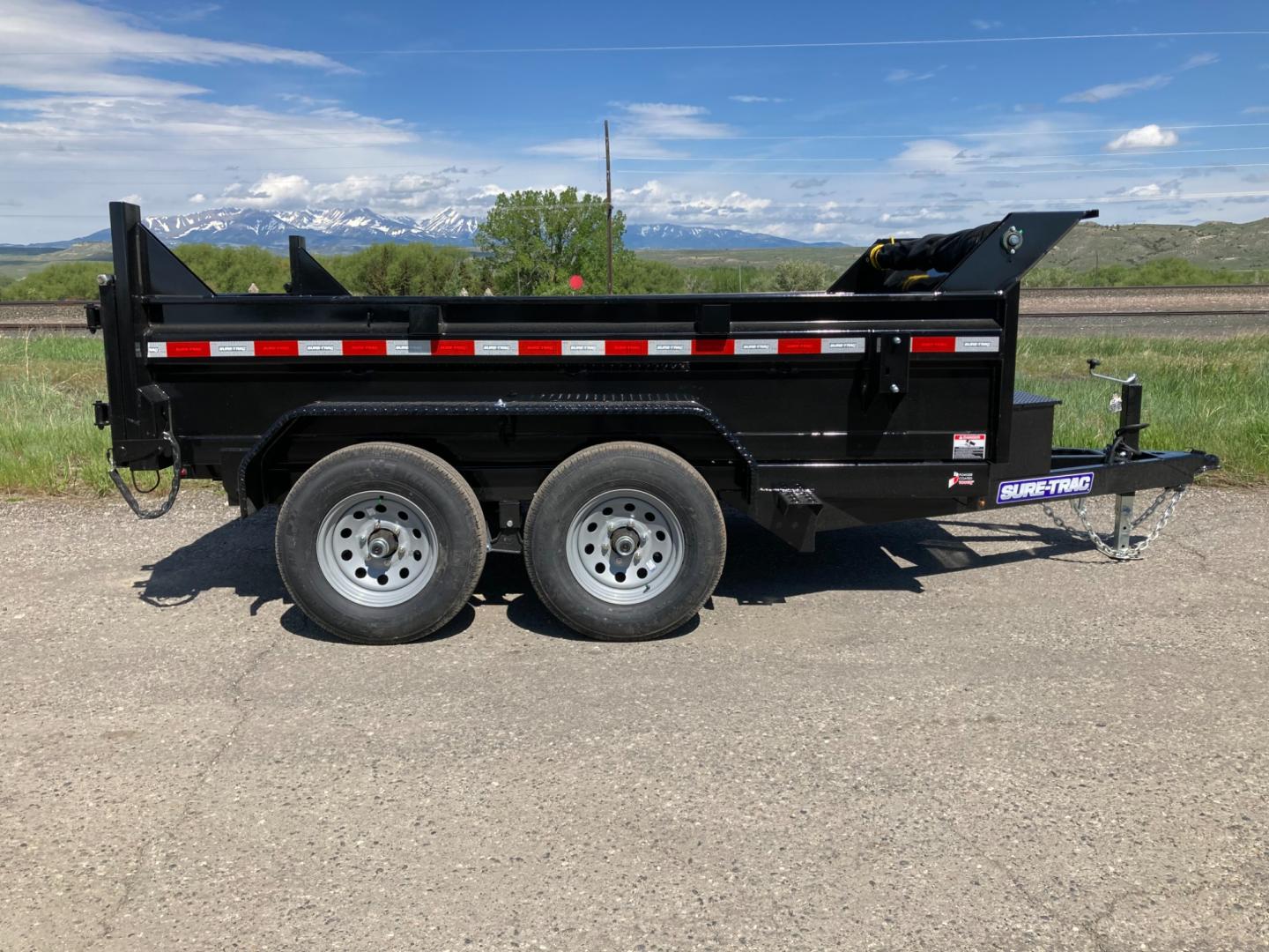 2025 Black SureTrac 6 x10 Lo Pro Dump Trailer , located at 310 West 1st Ave, Big Timber, MT, 59011, (406) 901-0517, 45.833511, -109.957809 - SURE-TRAC 6 X 10 LO PRO DUMP TRAILER, 10K GVW, SINGLE RAM HOIST WITH POWER UP/DOWN, EZ LUBE HUBS, DUAL REAR GATE, ELECTRIC BRAKES BOTH AXLES, (5) D-RING TIE-DOWNS, LED LIGHTS, REAR STOW RAMPS, MESH TARP, DEEP CYCLE BATTERY, 225-15" - 8 PLY RADIAL TIRES, SPARE TIRE CARRIER, 7K DROP FOOT JACK, LOCKABL - Photo#0