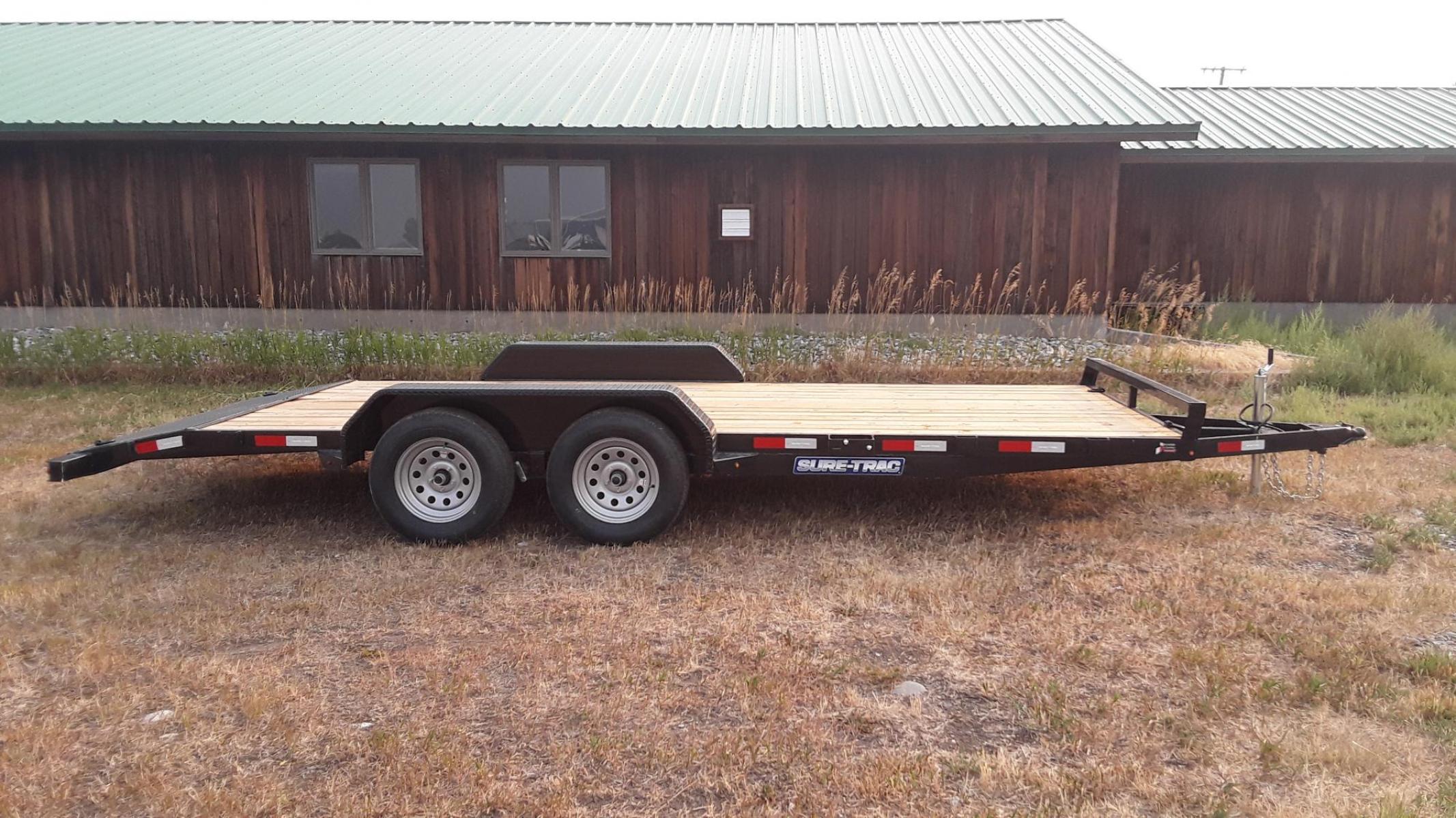 2023 Black SureTrac 7 x 18 - 7K Car Hauler , located at 310 West 1st Ave, Big Timber, MT, 59011, (406) 860-8510, 45.833511, -109.957809 - SURE-TRAC 7 X 18 C-CHANNEL CAR HAULER, 7K GVW, ELECTRIC BRAKES BOTH AXLES, REAR STOW RAMPS, LED LIGHTS, TREATED WOOD DECK, POWDER COAT FINISH, REMOVABLE FENDER ON DRIVERS SIDE, (4) D-RING TIE DOWNS, STAKE POCKETS, 2' TREAD PLATE DOVETAIL, EZ LUBE HUBS, 15' RADIAL TIRES, SPRING SUSPENSION, SPARE MOUN - Photo #1