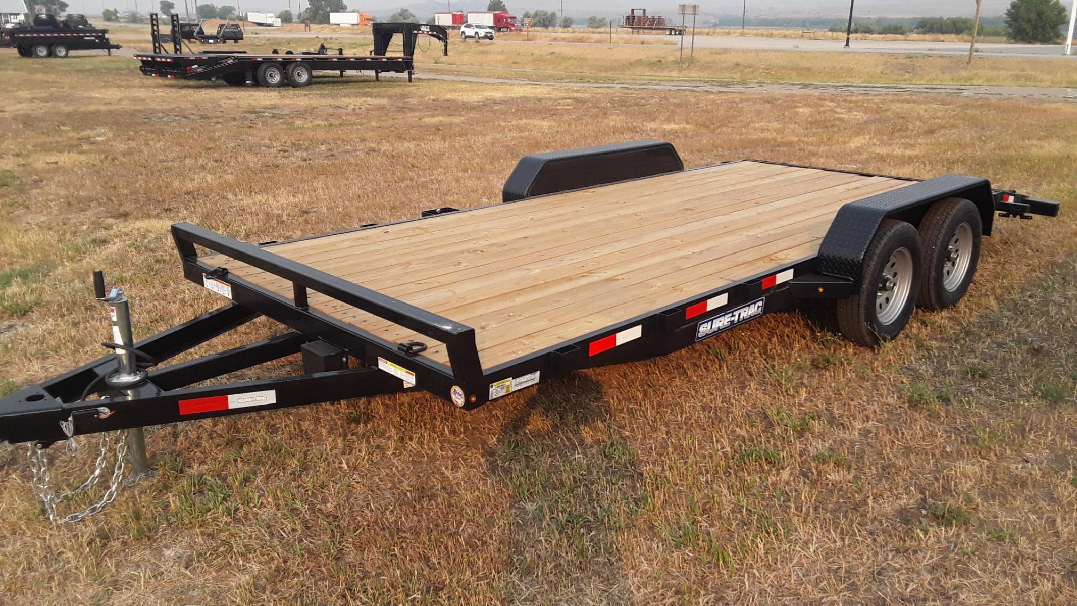 2023 Black SureTrac 7 x 18 - 7K Car Hauler , located at 310 West 1st Ave, Big Timber, MT, 59011, (406) 860-8510, 45.833511, -109.957809 - SURE-TRAC 7 X 18 C-CHANNEL CAR HAULER, 7K GVW, ELECTRIC BRAKES BOTH AXLES, REAR STOW RAMPS, LED LIGHTS, TREATED WOOD DECK, POWDER COAT FINISH, REMOVABLE FENDER ON DRIVERS SIDE, (4) D-RING TIE DOWNS, STAKE POCKETS, 2' TREAD PLATE DOVETAIL, EZ LUBE HUBS, 15' RADIAL TIRES, SPRING SUSPENSION, SPARE MOUN - Photo #4